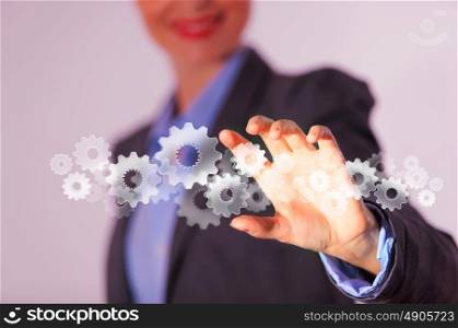 Business structure. Image of businesswoman touching gear elements. Mechanism concept