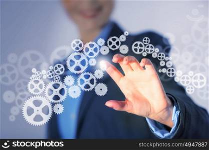 Business structure. Image of businesswoman touching gear elements. Mechanism concept