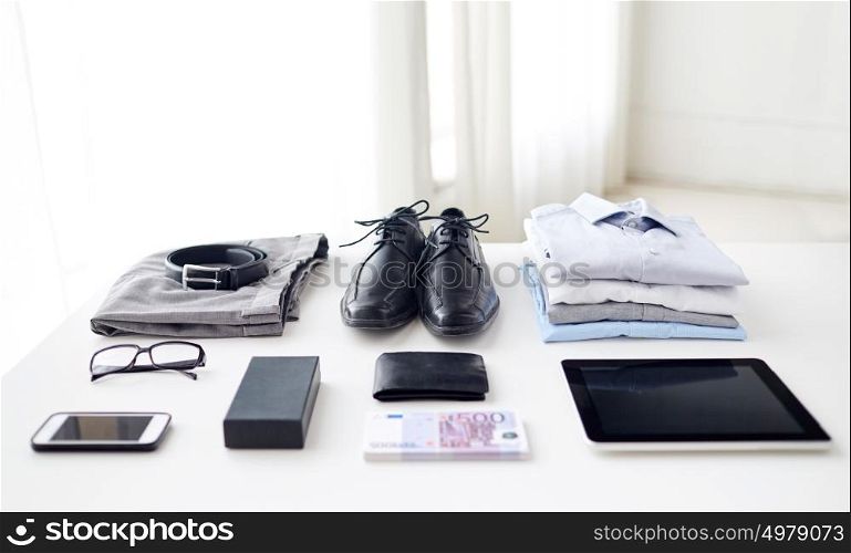 business, style and objects concept - formal male clothes, gadgets and personal stuff on table at home. clothes, gadgets and business stuff on table