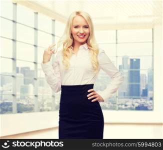 business, style and people concept - smiling businesswoman, student or secretary over city view in office window background