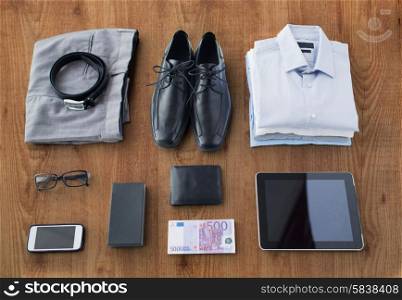 business, style, clothes and objects concept - close up of formal male clothes and personal stuff on wooden table at home
