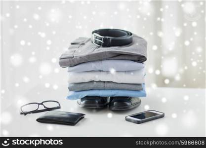 business, style, clothes and objects concept - close up of formal male clothes and personal stuff on table at home over snow effect