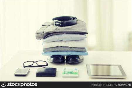 business, style, clothes and objects concept - close up of formal male clothes and personal stuff on table at home