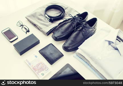 business, style, clothes and objects concept - close up of formal male clothes and personal stuff on table at home