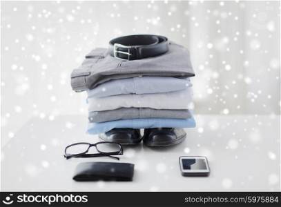 business, style, clothes and objects concept - close up of formal male clothes and personal stuff on table at home over snow effect
