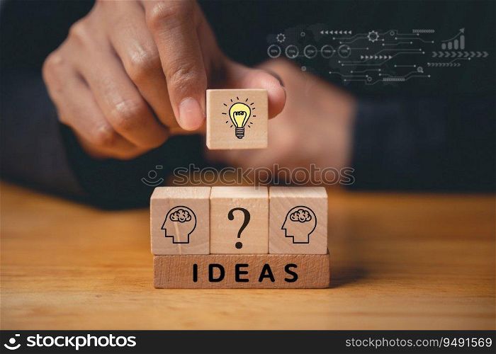Business success and support through consulting. Wood block with light bulb icon on hand against. New initiative and strategy brainstorm for digital transformation. Creative inspiration for innovation