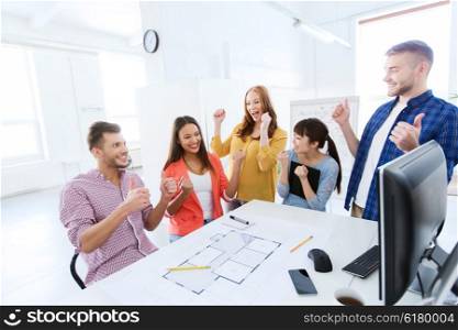 business, success, architecture, gesture and people concept - happy international creative architect team or students with blueprint celebrating triumph at office