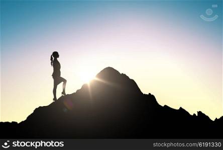 business, success, career, achievement and people concept - silhouette of businesswoman raising up to mountain top over sky and sun light background