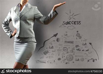 Business success. Close up of businesswoman and sketches at background