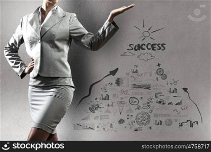 Business success. Close up of businesswoman and sketches at background