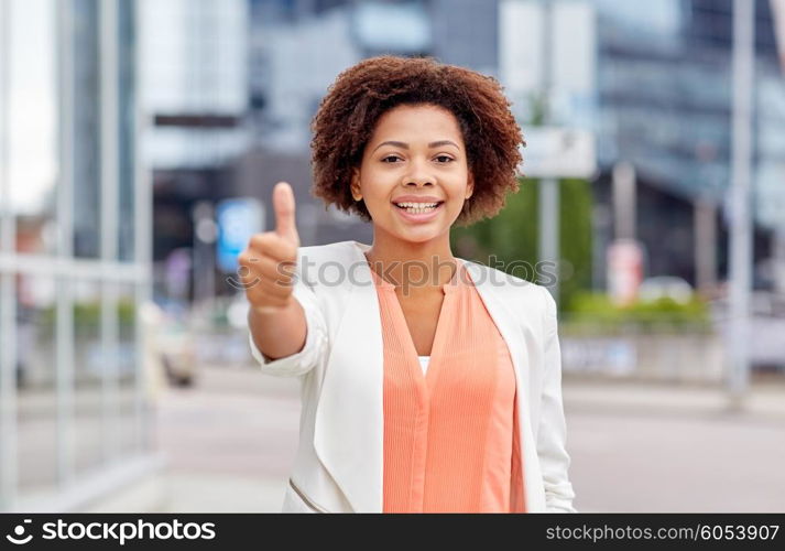 business, success, gesture and people concept - young smiling african american businesswoman showing thumbs uo in city