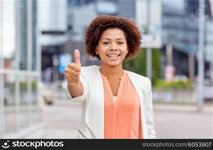 business, success, gesture and people concept - young smiling african american businesswoman showing thumbs uo in city