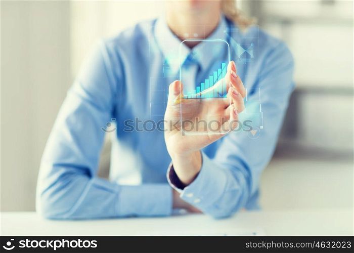 business, success, statistics, technology and people concept - close up of woman hand holding and showing transparent smartphone with chart at office