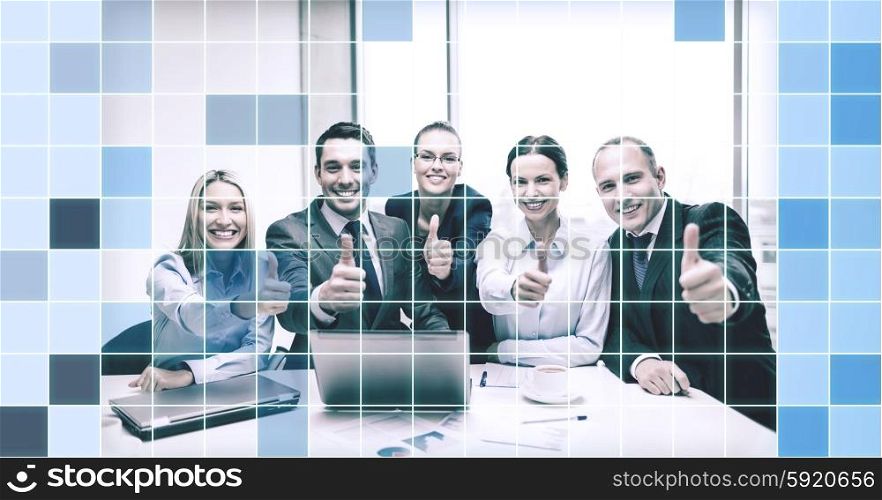 business, success, technology and office concept - smiling business team with laptop computer, papers and coffee showing thumbs up in office over blue squared grid background