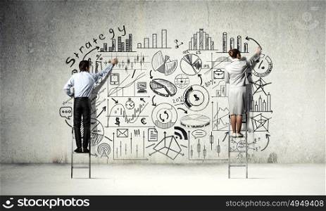 Business successful strategy. Back view of businessman and businesswoman standing on ladder and drawing plan on wall
