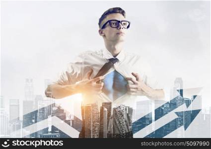 Business super hero double exposure. Business superhero double exposure concept. Young businessman showing super hero suit under his shirt