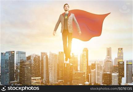 Business super hero hover over city skyline. Business superhero. Businessman in sketch super hero suit hovering over down town on sunset.
