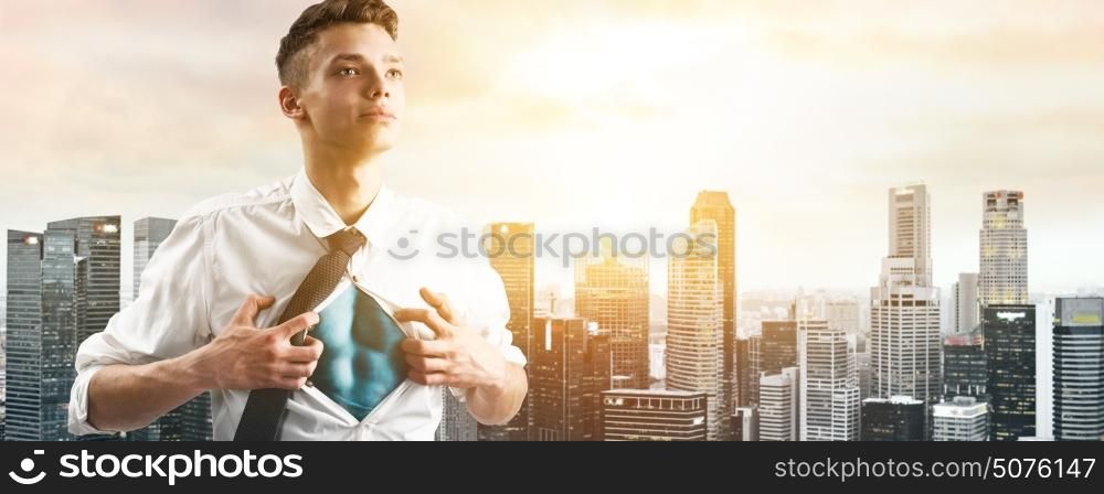 Business super hero hover over city skyline. Business superhero. Young businessman showing super hero suit under his shirt down town on sunset.