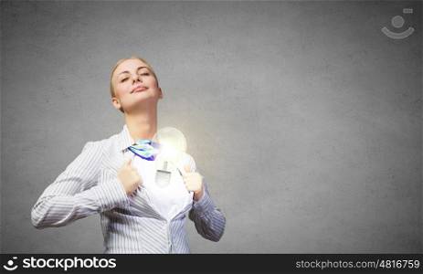 Business super power. Young blond businesswoman opening her shirt like superhero