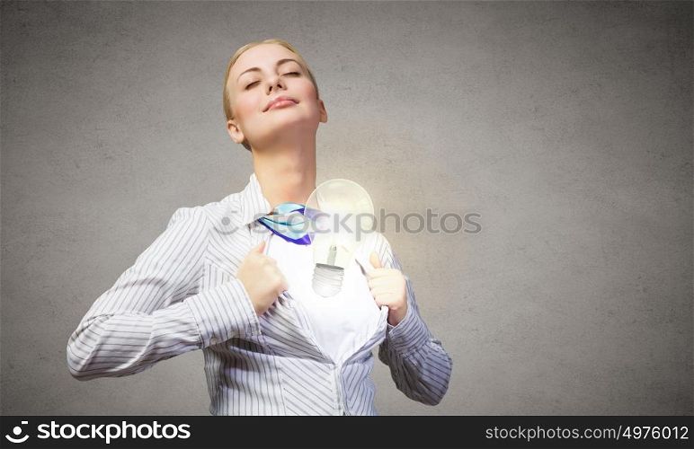 Business super power. Young blond businesswoman opening her shirt like superhero