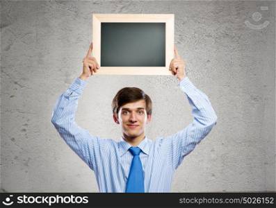 Business swith frame. Handsome businessman holding blank frame. Place for text