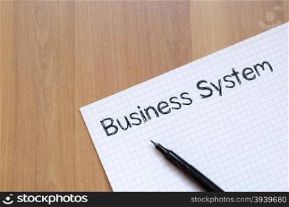 Business system text concept write on notebook with pen