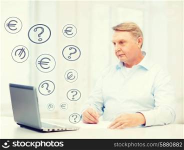business, tax and office concept - old man with laptop filling a form at home
