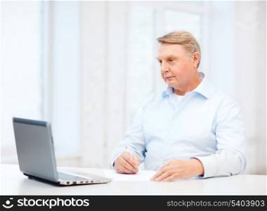 business, tax, office, school and education concept - old man filling a form at home