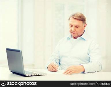 business, tax, office, school and education concept - old man filling a form at home