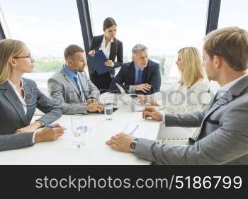 Business team at briefing. Business people team at briefing discuss statistics data diagrams