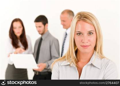 Business team attractive woman with colleagues discussing in the back