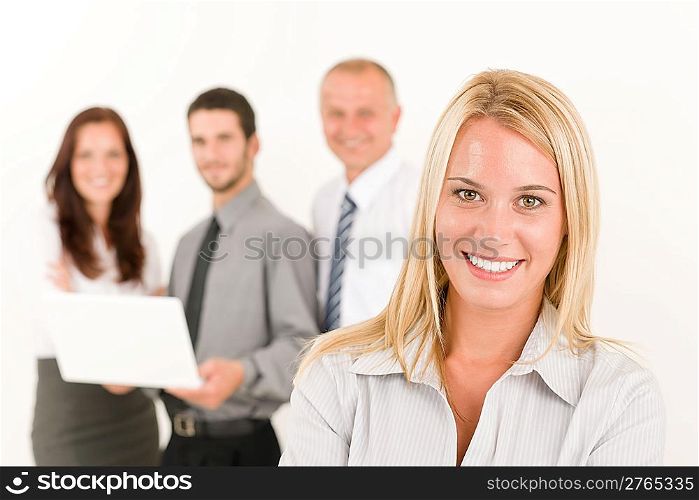 Business team attractive woman with colleagues posing in the back