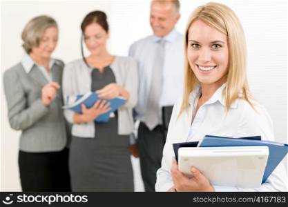 Business team attractive woman with happy colleagues discussing in back