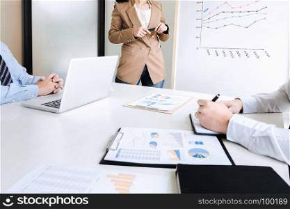 business team brainstorming discussing sale performance on white board while presentation in modern office room