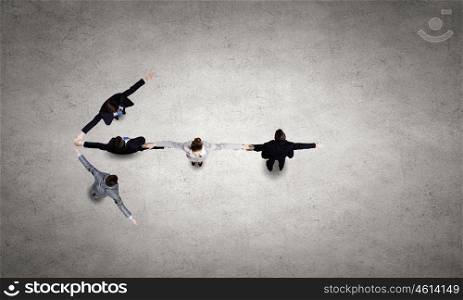 Business team. Business people with stretched arms making figure of arrow