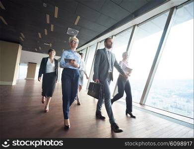 business team, businesspeople group walking at modern bright office interior