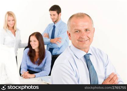 Business team close-up of senior businessman with attractive happy colleagues
