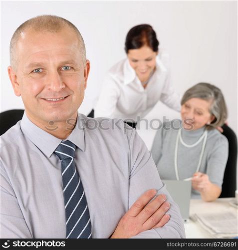 Business team close-up of senior businessman with attractive happy colleagues