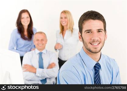 Business team close-up of young businessman with attractive happy colleagues