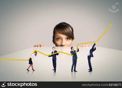 Business team concept. Businesswoman looking from under the table at businessteam