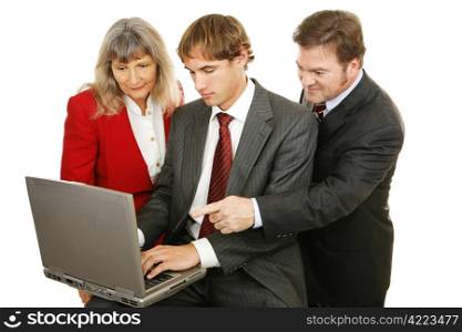 Business team consisting of diverse ages, working together on the computer. Isolated on white.