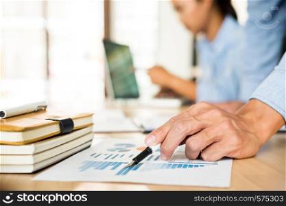 Business team hands at working with plan on office desk and modern digital computer laptop. Administrator financial inspector and secretary making report, calculating balance.