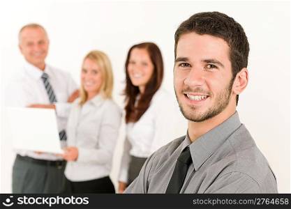 Business team handsome young man with colleagues posing in back