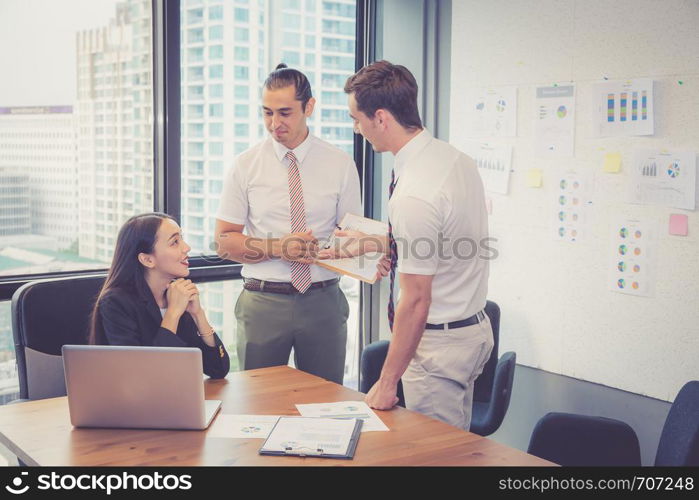 Business team having a meeting using laptop during a meeting and presents profit with chart and graph, leader talking employee with present report analysis and planning with brainstorm in teamwork.