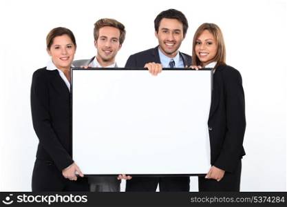 Business team holding blank poster