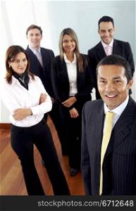 Business team in an office with a male manager leading it