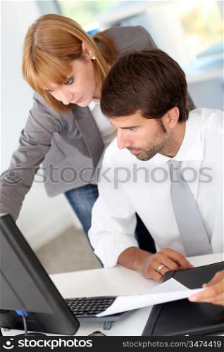 Business team in office working on desktop computer