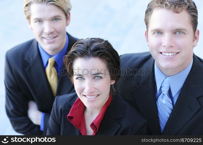 Business Team Looks Up and smiles as they stand together in unity