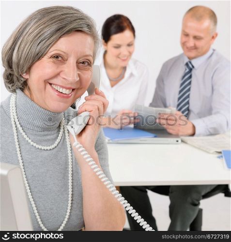 Business team meeting executive senior businesswoman calling on phone