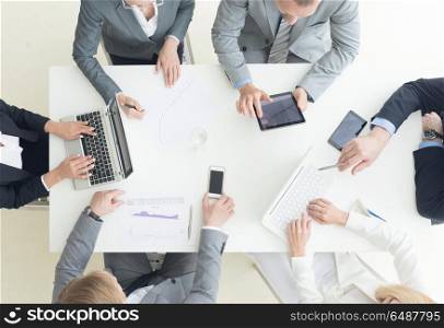 Business team meeting. People in office working with laptop computer and financial reports in desk. Business team meeting